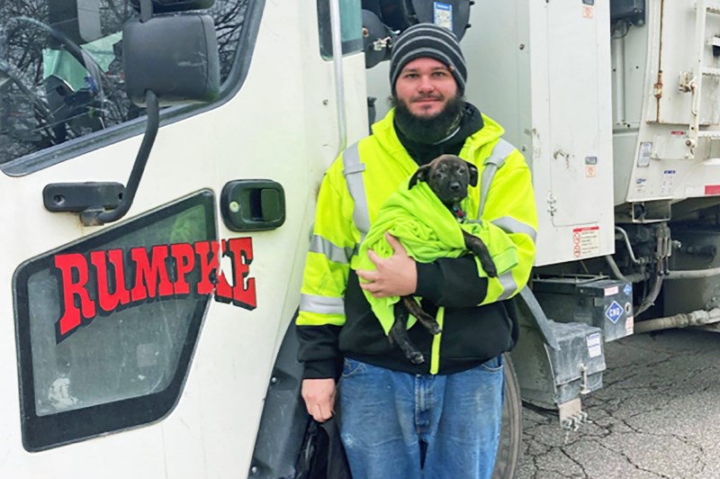 Garbage Truck Driver Rescues Scared, Injured Puppy Left in Roadside Backpack